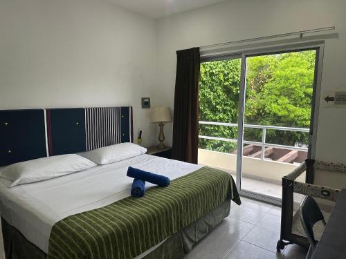 a bedroom with a bed and a large window at Cozy Apartments in Puerto Morelos in Puerto Morelos
