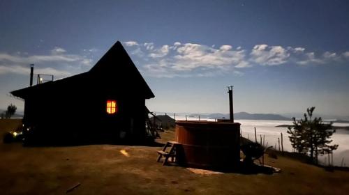 a black barn with a window on the side of it at Vikendica RANKOVIĆI in Mokra Gora