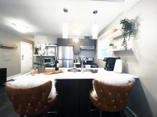 a kitchen with a counter and two bar stools at Stylish Boutique Studio in London