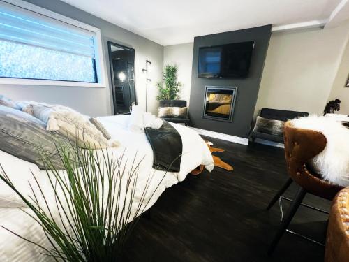a bedroom with a bed and a tv and a couch at Stylish Boutique Studio in London