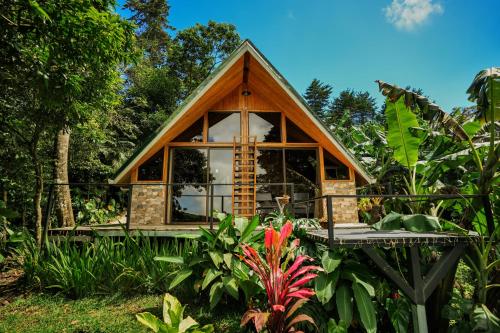 a tiny house in the middle of a garden at Tityra Lodge in Monteverde Costa Rica