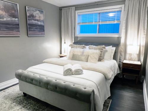 a bedroom with a large bed with two towels on it at The Cosmopolitan in Wortley Village in London