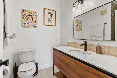 a bathroom with a sink and a toilet and a mirror at 2br Condo - Sleeps 6 - Garage - Wifi Laguna in Laguna Niguel