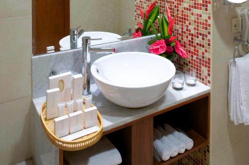 a bathroom with a sink and a white bowl at Montreal Barsha Hotel in Dubai