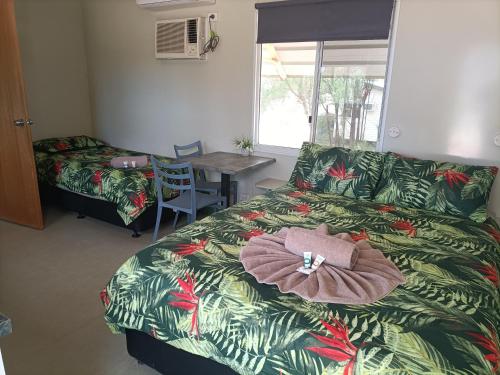 Un dormitorio con una cama con una toalla. en Cunnamulla Tourist Park, en Cunnamulla