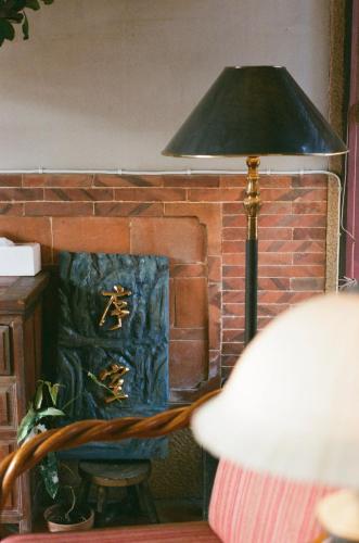 a lamp in front of a brick fireplace at 序室 Narrative in Jinhu
