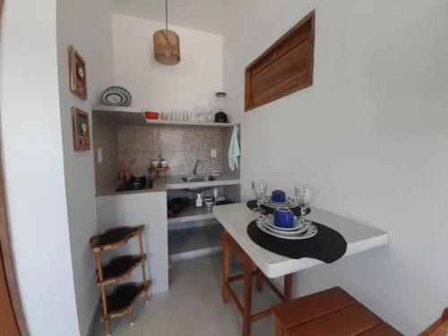 a kitchen with a table and chairs in a room at Flats Lages in Pôrto de Pedras