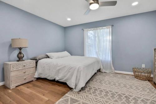 a bedroom with a bed and a dresser and a window at 3 Bedroom Hilltop Escape with 5 Private Acres and Hot Tub in Marlboro