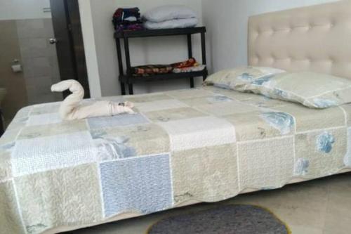 a bedroom with a bed with a swan on it at Casa vacacional en Pedro Vicente Maldonado in Pedro Vicente Maldonado