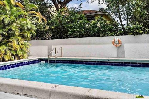 a swimming pool with a lifebuoy and a lifesaver at Lovely 2/2 condo in Miami shores in Miami