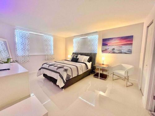 a bedroom with a bed and a chair in it at Lovely 2/2 condo in Miami shores in Miami
