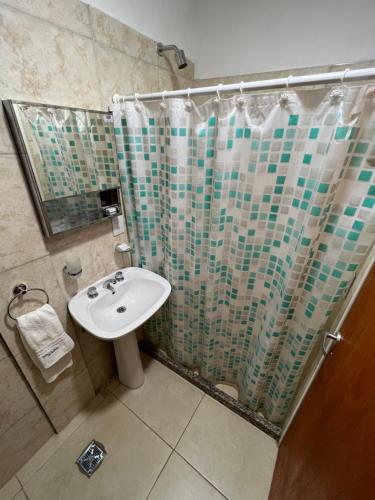 baño con lavabo y cortina de ducha en Delsa en Concordia