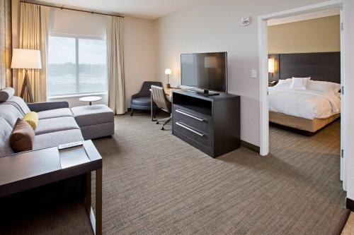 a hotel room with a bed and a television at Residence Inn by Marriott Louisville East/Oxmoor in Louisville