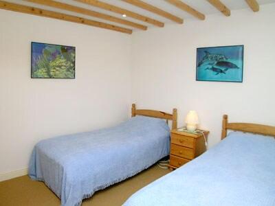 a bedroom with two beds and a night stand with a nightstand at The Old Barn in Commondale