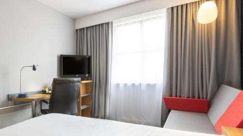 a hotel room with a bed and a desk and a window at Holiday Inn Express Aberdeen City Centre by IHG in Aberdeen