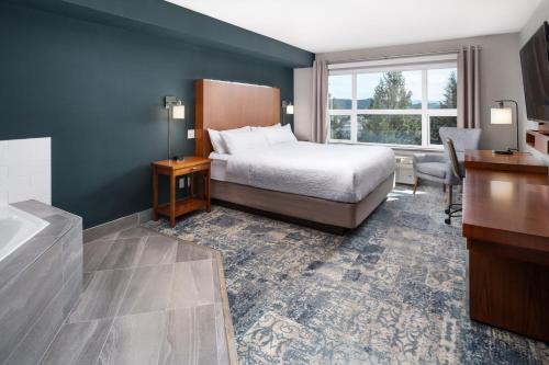 a hotel room with a bed and a bathroom at Four Points by Sheraton Victoria Gateway in Victoria