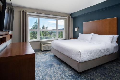 a bedroom with a bed and a large window at Four Points by Sheraton Victoria Gateway in Victoria