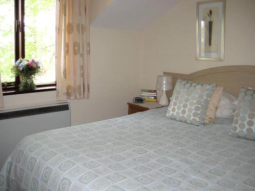a bedroom with a large bed and a window at The Granary in Burscough