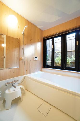 a bathroom with a tub and a toilet and a sink at ANGO KYOTO Ⅰ in Kyoto