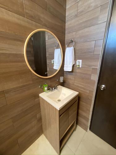 a bathroom with a sink and a mirror at Depto nuevo “Tortuga”,Céntrico a 4 cuadras malecón in Mazatlán