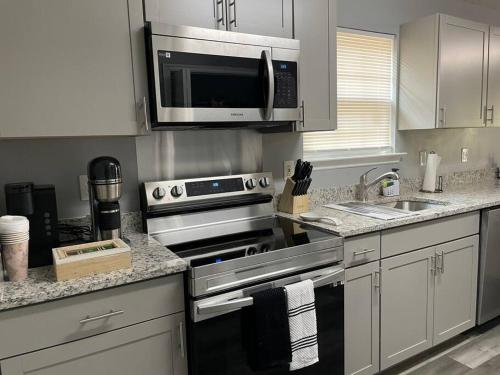 a kitchen with a stainless steel stove and a microwave at Downtown Home in Chattanooga in Chattanooga