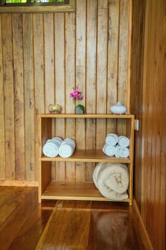 a wooden room with a shelf with towels at Tityra Lodge in Monteverde Costa Rica