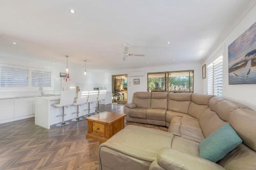 a living room with a couch and a kitchen at Absolute Waterfront in North Haven