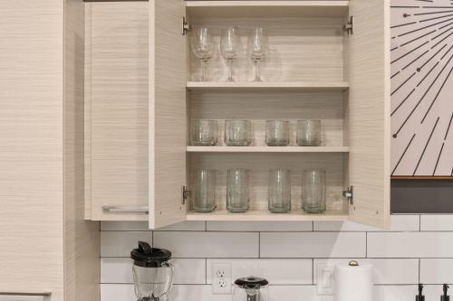 a kitchen with wine glasses sitting on shelves at Affordable APT in Salt Lake City Ideal Location in Salt Lake City