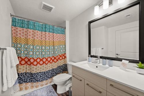 a bathroom with a sink and a shower curtain at Affordable APT in Salt Lake City Ideal Location in Salt Lake City