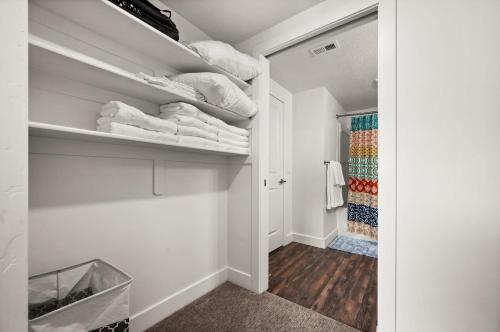 a walk in closet with white towels on shelves at Affordable APT in Salt Lake City Ideal Location in Salt Lake City