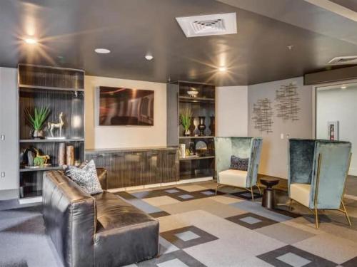 a living room with a leather couch and two chairs at Affordable APT in Salt Lake City Ideal Location in Salt Lake City