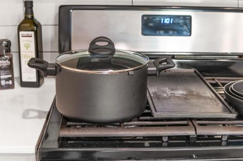 a pot on a stove with a bottle of wine at Affordable APT in Salt Lake City Ideal Location in Salt Lake City