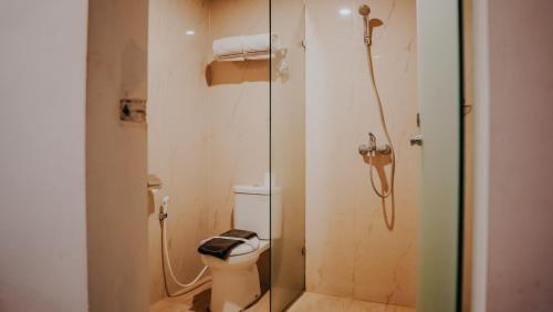 a bathroom with a toilet and a shower at Villa Rancabango Hotel & Resort Garut in Tarogong