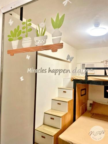 a room with boxes and plants on the wall at Homestay by ViJiTa 2bedroom condo in Manila