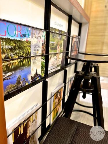 a display of pictures on a wall with a stool at Homestay by ViJiTa 2bedroom condo in Manila