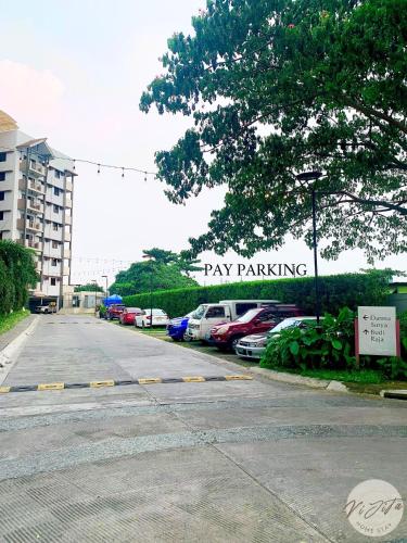 a parking lot with a parking lot with cars parked at Homestay by ViJiTa 2bedroom condo in Manila