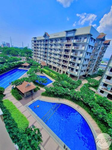 an aerial view of a large apartment building with two pools at Homestay by ViJiTa 2bedroom condo in Manila