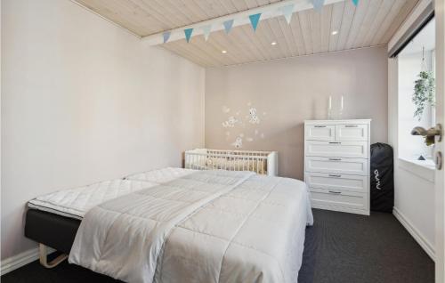 a bedroom with a white bed and a dresser at Cozy Home In Egernsund With Wifi in Egernsund