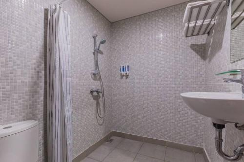 a bathroom with a shower and a sink at Victoria Villa Seminyak in Seminyak