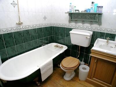 a bathroom with a tub and a toilet and a sink at Rustic Cottage in Bowness-on-Windermere