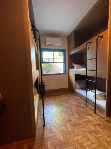 a room with bunk beds and a window at Youse Hostel in Sao Paulo
