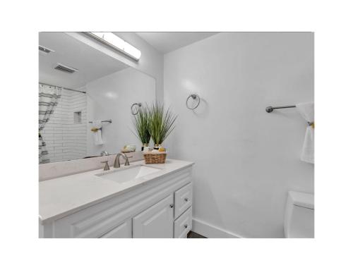 a bathroom with a sink and a large mirror at Quaint 3/2.5 home in Fort Dupont in Washington