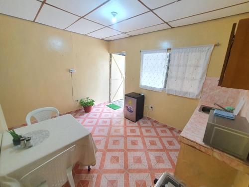 a kitchen with a sink and a tv in a room at Chelox Panama Airport in Cabuya