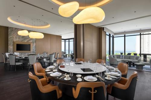 a dining room with a large table and chairs at The Westin Yantai in Yantai