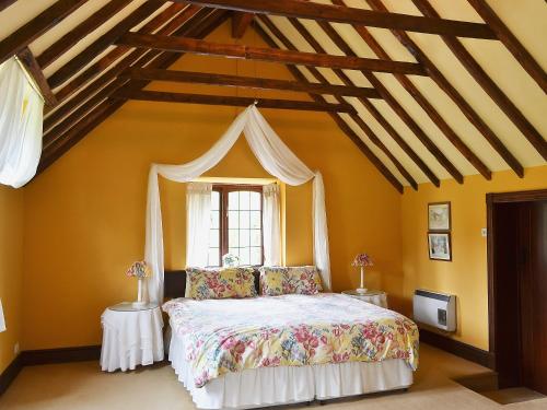 a bedroom with a bed and a window at Mill Cottage in Mathon