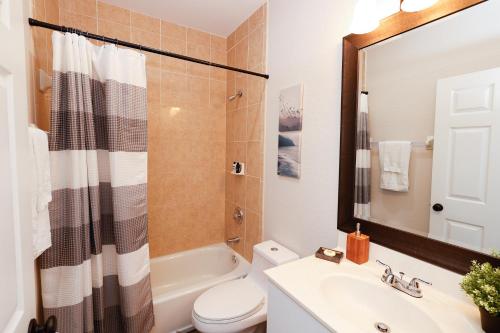 a bathroom with a sink and a toilet and a shower at Stylish 2BR unit w/ hot tub 5 mins from the beach! in Bonita Springs
