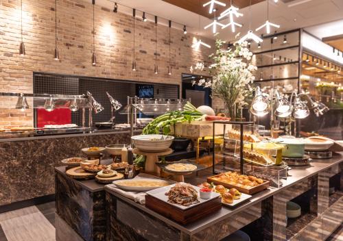 a buffet line with many different types of food at APA Hotel & Resort Osaka Umeda Eki Tower in Osaka
