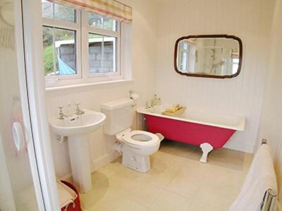 a bathroom with a sink and a toilet and a bath tub at Owl Cottage in Kilmote