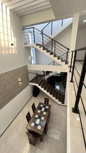 a room with a table and a staircase at Bolgoda Lake Villa in Moratuwa