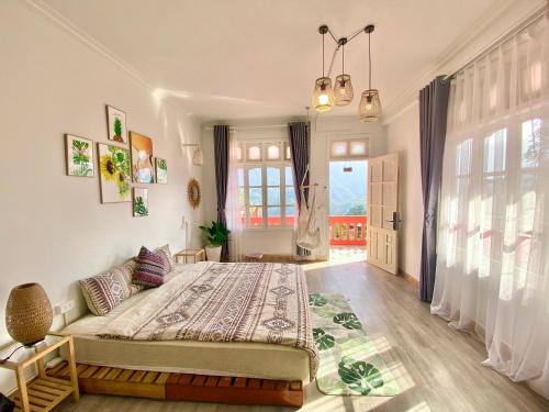 a bedroom with a large bed and a large window at D Home Sapa 3 in Sa Pa